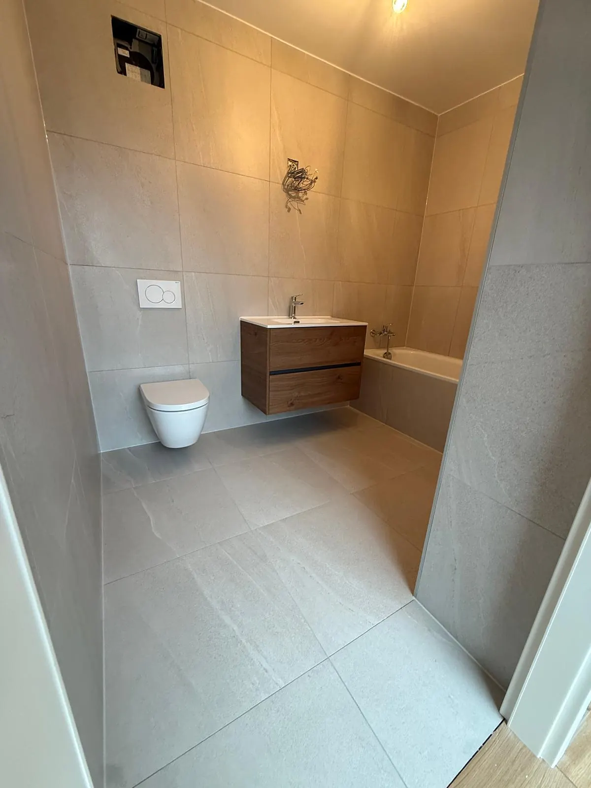 Salle de bain beige en grands formats, sol et murs assortis